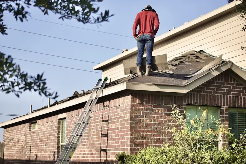 Professional roofer working on a residential roof in Olde Town East
